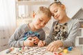 Preschoolers play and learn English letters using wooden alphabet. Royalty Free Stock Photo