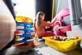 Preschooler girl child in day care center playing with dolls toys