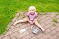 Preschooler girl drawing with chalk outdoors Royalty Free Stock Photo