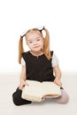 Preschooler girl reading a book.