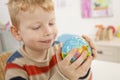 Preschooler with globe in the classroom Royalty Free Stock Photo