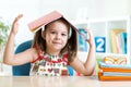 Preschooler kid girl with book over her head Royalty Free Stock Photo