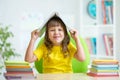 Preschooler kid girl with book over her head Royalty Free Stock Photo