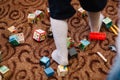 Preschooler kid playing with colorful wooden blocks. Educational toys in kindergarten scattered on the floor Royalty Free Stock Photo