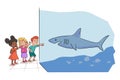 Preschooler kids group standing by shark aquarium