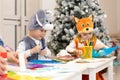 Preschooler kids weared funny clothes on lesson in classroom. Children prepare to christmas holiday in kindergarten. Royalty Free Stock Photo