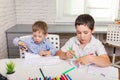 Preschooler little boy drawing in room. Boy is studying drawing. Royalty Free Stock Photo