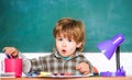 Preschooler near the blackboard. Young student. Education and children. Happy smiling pupil drawing at the desk. Back to Royalty Free Stock Photo