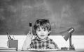 Preschooler near the blackboard. Young student. Education and children. Happy smiling pupil drawing at the desk. Black Royalty Free Stock Photo