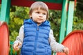 Preschooler playing on playground in park. Child development concept