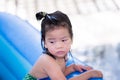 Preschoolers get wet. The girl looks bored. She shows a sullen or upset face. Royalty Free Stock Photo