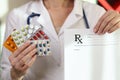 Prescription and assortment of pills pack in hands of doctors close-up.