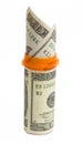 Prescription bottle with $20 bills isolated.