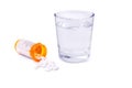Prescription bottle and pills and glass of water isolated Royalty Free Stock Photo