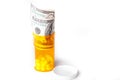 Prescription Drugs in a container with a hundred dollar bill Royalty Free Stock Photo