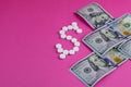 Prescription drugs on a money background representing rising healthcare costs Royalty Free Stock Photo