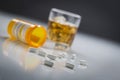 Prescription Drugs Spilled From Fallen Bottle Near Glass of Alcohol Royalty Free Stock Photo