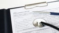 Prescription form lying on table with stethoscope and silver pen Royalty Free Stock Photo