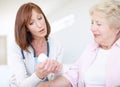 Prescription medication - Senior Care. Mature nurse explains the dosage and side effects of the medication to an elderly Royalty Free Stock Photo