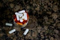 Prescription pill bottle with white capsules on marble countertop