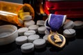 Prescription pills, a bottle of alcohol and a purple heart medal, illustrating the reality of Royalty Free Stock Photo