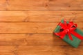 Present in gift box on wood background with copy space Royalty Free Stock Photo