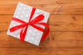 Present in gift box on wood background with copy space Royalty Free Stock Photo