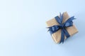 Present box with blue ribbon and bow top view on empty space blue background. Father's day gift Royalty Free Stock Photo