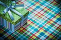 Present box on colorful checked tablecloth celebrations concept