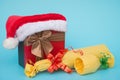 Present box covered by santa claus hat and wrapped wine Royalty Free Stock Photo