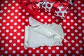 Present box vintage sheet of paper feather on polka-dot red fabr