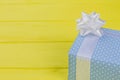 Present box wrapped in blue patterned paper. Royalty Free Stock Photo