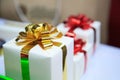 Present boxes package with gold and red ribbons as holiday gift boxes for festive giving seasons. Thanks, Happiness, Sharing, Royalty Free Stock Photo