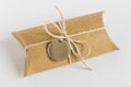 Present craft paper box wrapped with packthread and golden round metallic label Royalty Free Stock Photo