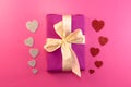 Present or gift box, paper heart and confetti on pink background top view. Valentines day greeting card. Flat lay style Royalty Free Stock Photo