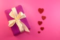 Present or gift box, paper heart and confetti on pink background top view. Valentines day greeting card. Flat lay style Royalty Free Stock Photo