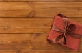 Present in gift box on wood background with copy space Royalty Free Stock Photo