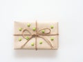 A present or gift box wrapped by rough brown recycled paper and tied with brown hemp rope as ribbon with green rubber star isolat Royalty Free Stock Photo