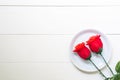 Present gift with red rose flower and dish on wooden table, 14 February of love day with romantic copy space, valentine holiday Royalty Free Stock Photo