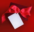 Present with red ribbon and card. Royalty Free Stock Photo