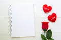 Present red rose flower and notebook and heart shape with copy space on wooden table Royalty Free Stock Photo