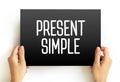 Present Simple - one of the verb forms associated with the present tense in modern english, text concept on card