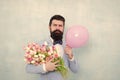 Present for spouse. Guy with air balloon. Birthday party. Bearded man hipster with flower bouquet. 8 march. Flowers for