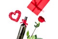 Present for Valentine day in red colors. Wine, rose, heart sign, gift box on white background top view