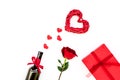 Present for Valentine day in red colors. Wine, rose, heart sign, gift box on white background top view copy space