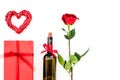 Present for Valentine day in red colors. Wine, rose, heart sign, gift box on white background top view copy space