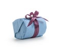 Present wrapped with blue paper with purple ribbon bow isolated on white background Royalty Free Stock Photo