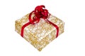 Present wrapped in gold-white paper with a red ribbon Royalty Free Stock Photo
