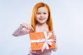 Delighted cheerful girl pointing at the gift box Royalty Free Stock Photo