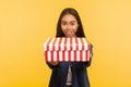 Present for you! Portrait of generous happy brunette girl with charming smile giving box to camera, sharing holiday gift